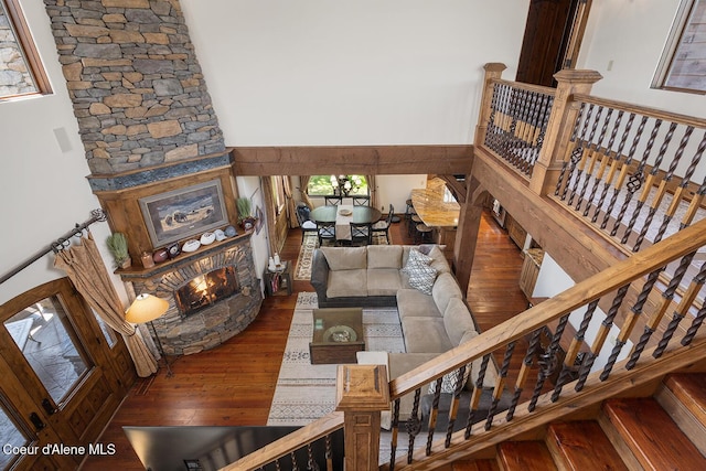 6012 W Quartzite Ln, Coeur Dalene, ID 83814 - living room with wood finished floors, a large fireplace, a towering ceiling, and stairway