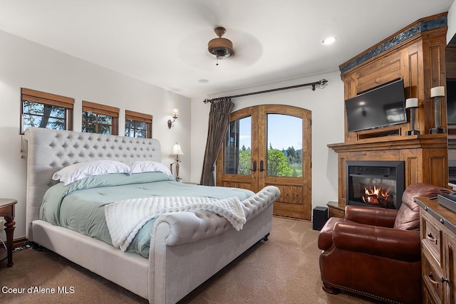 6012 W Quartzite Ln, Coeur Dalene, ID 83814 - bedroom with light colored carpet, french doors, a fireplace, access to exterior, and recessed lighting