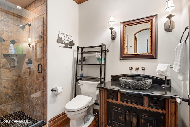 6012 W Quartzite Ln, Coeur Dalene, ID 83814 - full bathroom with a stall shower, vanity, toilet, wood finished floors, and baseboards
