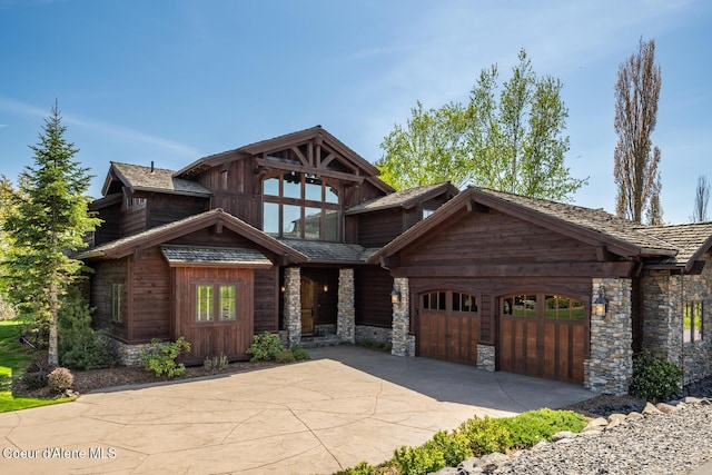6012 W Quartzite Ln, Coeur Dalene, ID 83814 - craftsman-style house with concrete driveway, stone siding, and an attached garage