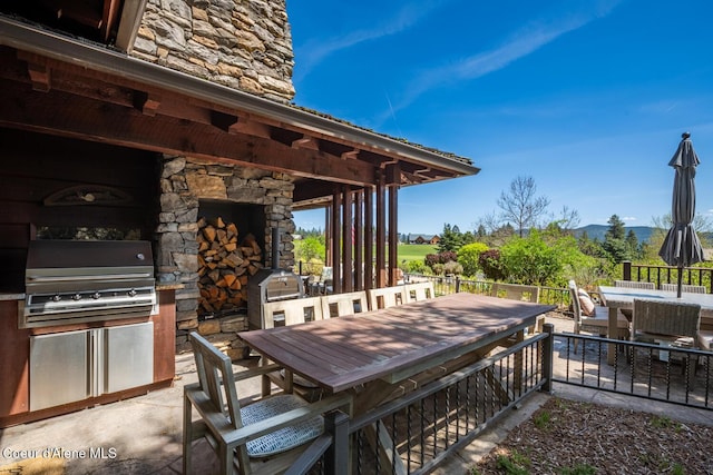 6012 W Quartzite Ln, Coeur Dalene, ID 83814 - view of patio with outdoor dining area, area for grilling, and a mountain view