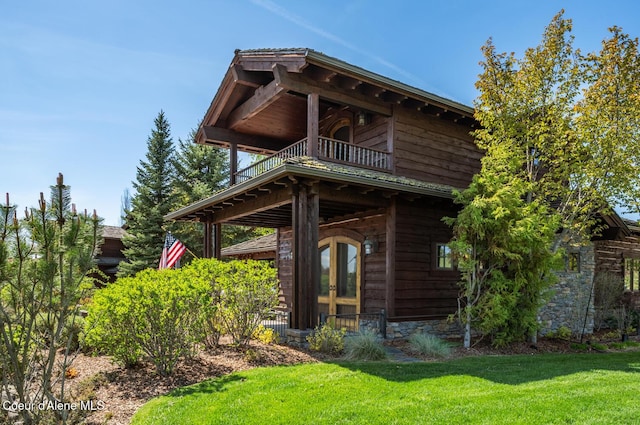 6012 W Quartzite Ln, Coeur Dalene, ID 83814 - back of house with a yard, a balcony, and stone siding