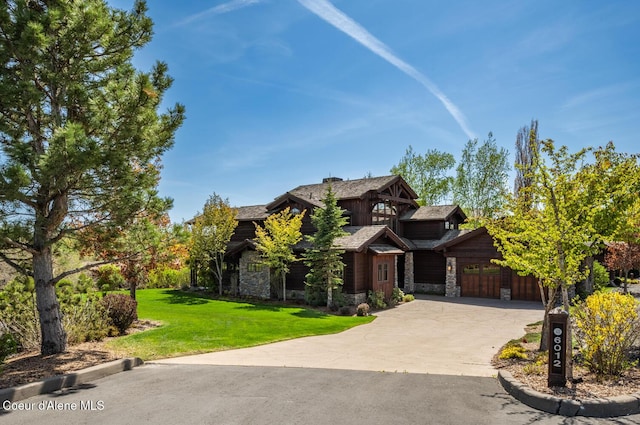 6012 W Quartzite Ln, Coeur Dalene, ID 83814 - view of front of home featuring stone siding, a front lawn, and driveway