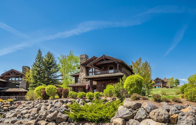 6012 W Quartzite Ln, Coeur Dalene, ID 83814 - rear view of house with a balcony and a chimney