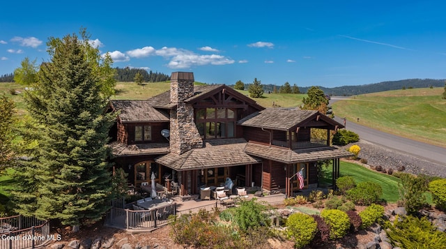6012 W Quartzite Ln, Coeur Dalene, ID 83814 - back of property with a balcony, a chimney, and a patio
