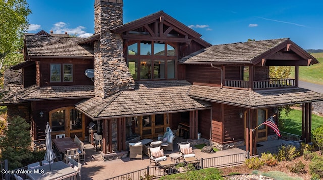 6012 W Quartzite Ln, Coeur Dalene, ID 83814 - rear view of property featuring a chimney and a patio area