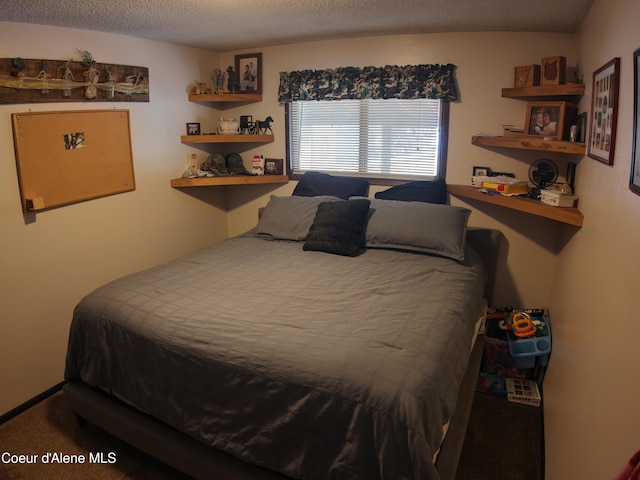 bedroom featuring carpet floors and a textured ceiling