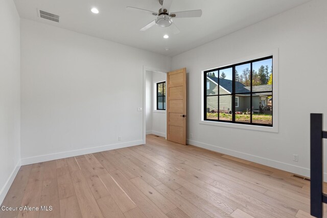 empty room with ceiling fan, light wood-style flooring, recessed lighting, baseboards, and visible vents