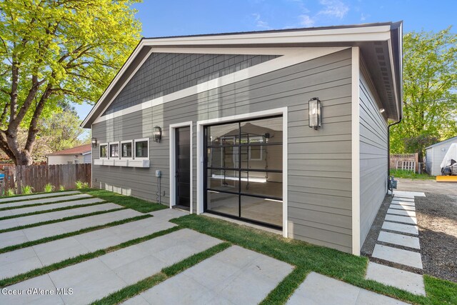 rear view of property featuring fence