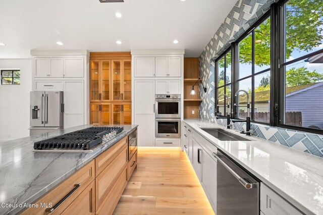 907 N B St, Coeur Dalene, ID 83814 - kitchen with a sink, appliances with stainless steel finishes, recessed lighting, light wood-style flooring, and white cabinets