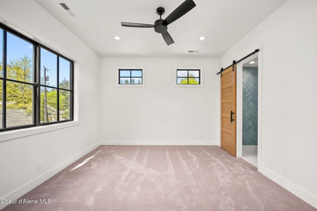 907 N B St, Coeur Dalene, ID 83814 - unfurnished bedroom with a barn door, carpet floors, baseboards, and recessed lighting