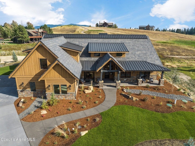 17056 S Lazurite Dr, Coeur Dalene, ID 83814 - view of front of property featuring a front lawn, stone siding, and a standing seam roof