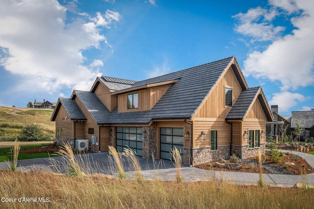 17056 S Lazurite Dr, Coeur Dalene, ID 83814 - view of front of home featuring driveway, ac unit, a patio area, and stone siding