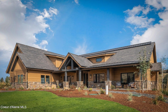 17056 S Lazurite Dr, Coeur Dalene, ID 83814 - craftsman inspired home with a front lawn, covered porch, stone siding, a standing seam roof, and metal roof