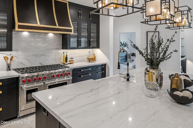 17056 S Lazurite Dr, Coeur Dalene, ID 83814 - kitchen featuring dark cabinetry, a notable chandelier, and double oven range