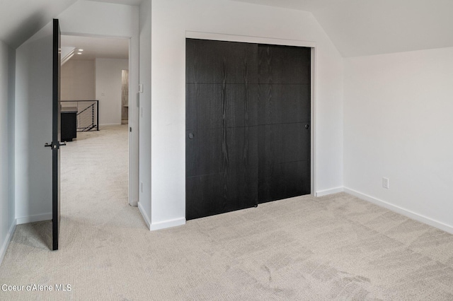 17056 S Lazurite Dr, Coeur Dalene, ID 83814 - unfurnished bedroom with baseboards, vaulted ceiling, carpet, and a closet