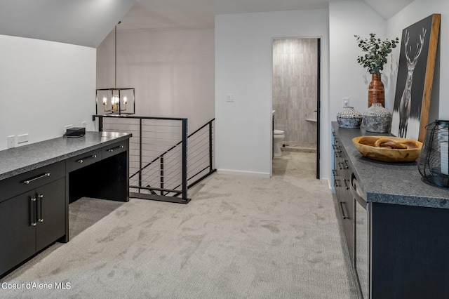 17056 S Lazurite Dr, Coeur Dalene, ID 83814 - kitchen featuring dark countertops, light colored carpet, an inviting chandelier, dark cabinets, and vaulted ceiling