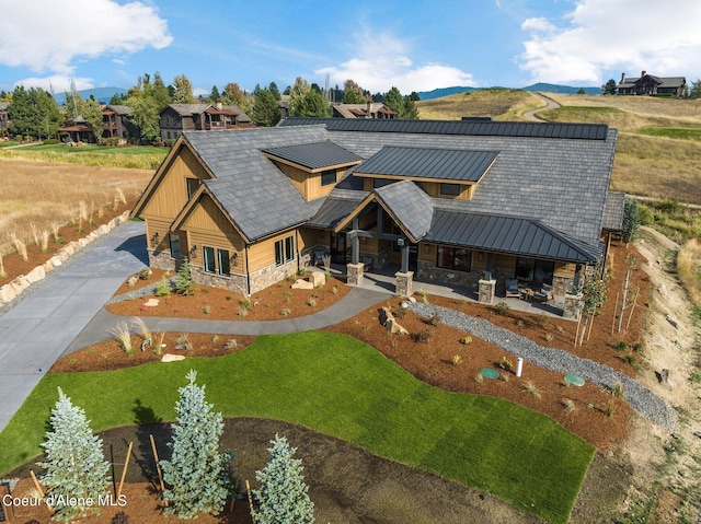 17056 S Lazurite Dr, Coeur Dalene, ID 83814 - view of front of home featuring board and batten siding, a patio area, stone siding, and metal roof