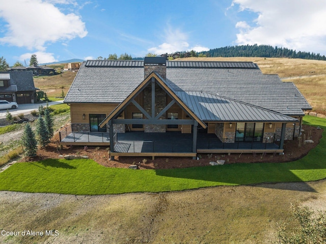17056 S Lazurite Dr, Coeur Dalene, ID 83814 - back of house featuring a chimney, metal roof, stone siding, and a standing seam roof