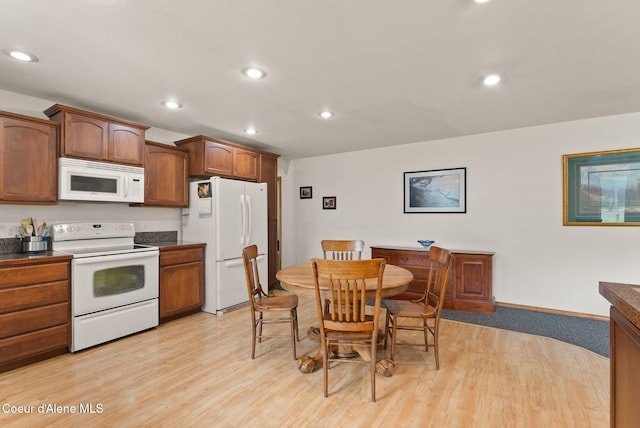 850 Hoop Loop, Priest River, ID 83856 - kitchen with white appliances, light wood finished floors, recessed lighting, dark countertops, and brown cabinets