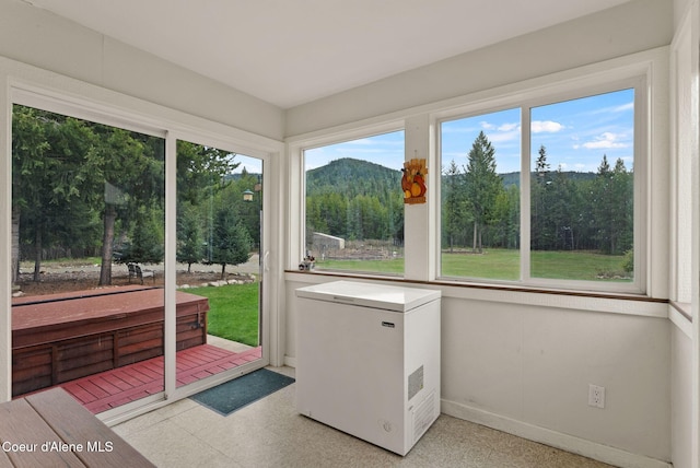 850 Hoop Loop, Priest River, ID 83856 - unfurnished sunroom with tile patterned floors, baseboards, and a mountain view