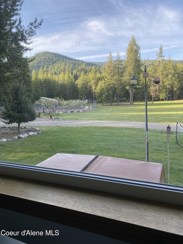 850 Hoop Loop, Priest River, ID 83856 - surrounding community featuring a wooded view and a lawn