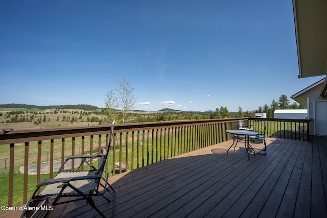 wooden terrace featuring a lawn