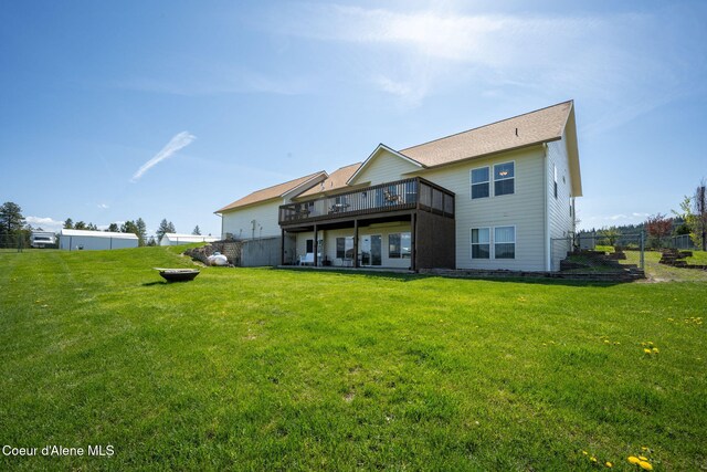 6035 W Conkling Rd, Worley, ID 83876 - rear view of house featuring a wooden deck, a yard, and fence