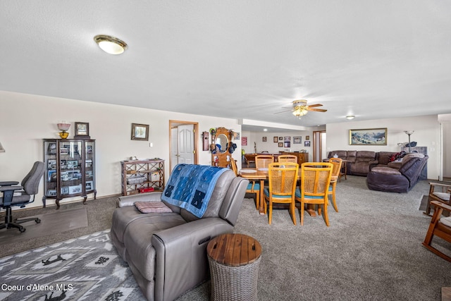 carpeted living area with ceiling fan