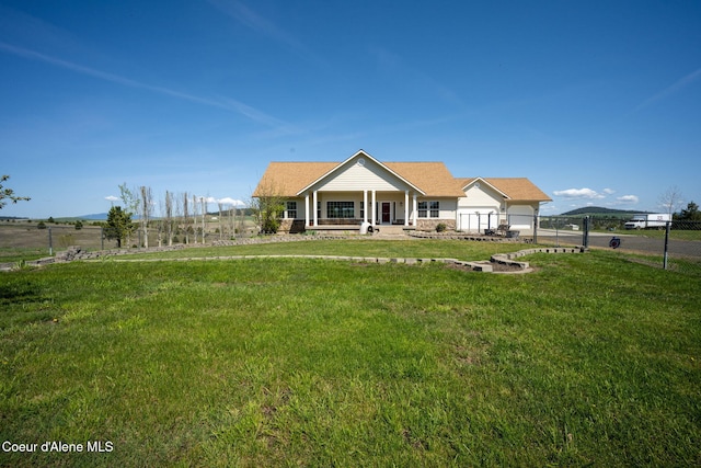 view of front of house featuring a porch, a front lawn, and fence