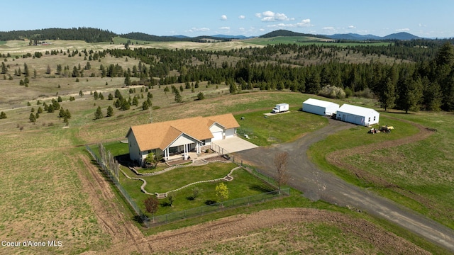 birds eye view of property with a mountain view and a rural view