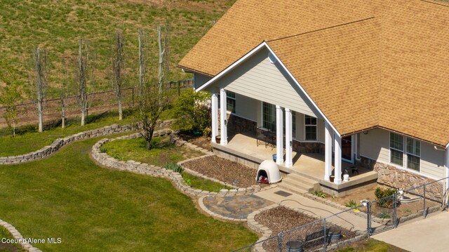 6035 W Conkling Rd, Worley, ID 83876 - exterior space with a front yard, a gate, fence private yard, a patio area, and stone siding