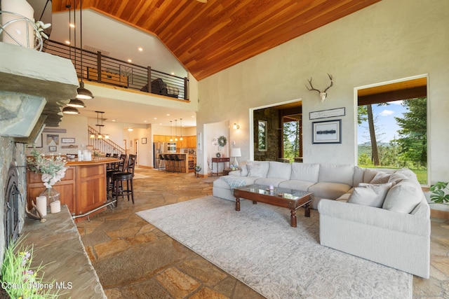 735 S Bushwacker Rd, Coeur Dalene, ID 83814 - living area with stairway, wooden ceiling, high vaulted ceiling, and stone tile floors