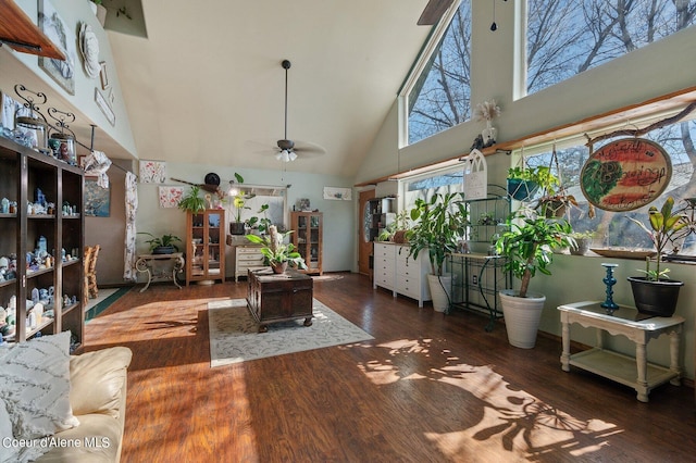 living area with wood finished floors, a ceiling fan, and high vaulted ceiling