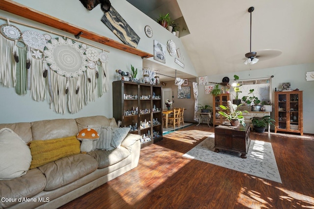 living area featuring wood finished floors, ceiling fan, and high vaulted ceiling