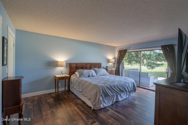 10792 N Magic Ct, Hayden, ID 83835 - bedroom featuring access to exterior, dark wood-style floors, a textured ceiling, and baseboards