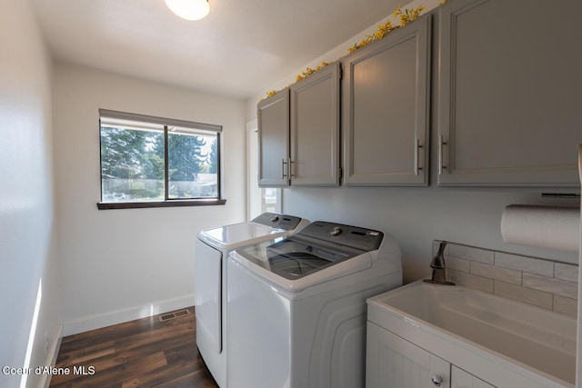 10792 N Magic Ct, Hayden, ID 83835 - clothes washing area featuring washer and dryer, cabinet space, dark wood finished floors, and baseboards