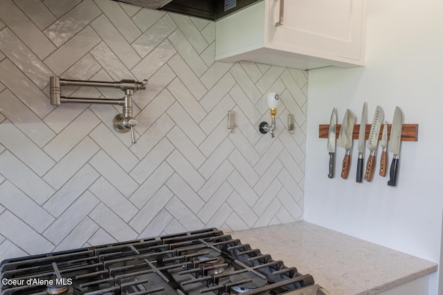 10792 N Magic Ct, Hayden, ID 83835 - kitchen featuring gas cooktop, decorative backsplash, light stone counters, and white cabinetry