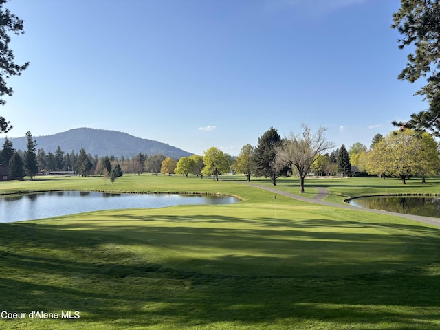 10792 N Magic Ct, Hayden, ID 83835 - surrounding community with a water and mountain view, a lawn, and view of golf course