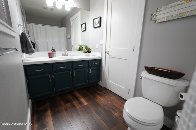 10792 N Magic Ct, Hayden, ID 83835 - bathroom featuring wood finished floors, toilet, and vanity