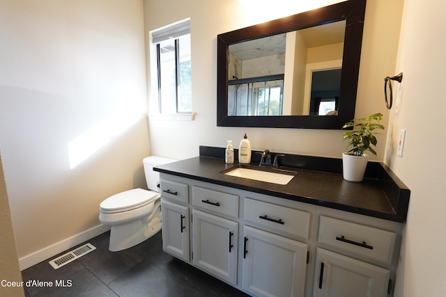 10792 N Magic Ct, Hayden, ID 83835 - bathroom featuring toilet, vanity, a shower with door, baseboards, and tile patterned floors