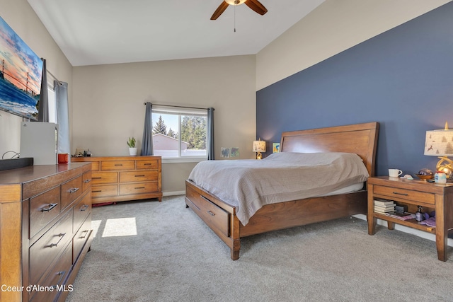 bedroom with a ceiling fan, light carpet, and vaulted ceiling