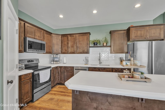 kitchen featuring light countertops, appliances with stainless steel finishes, and a sink