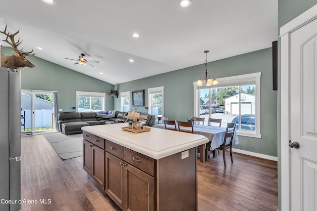 kitchen featuring vaulted ceiling, dark wood-style flooring, decorative light fixtures, and recessed lighting