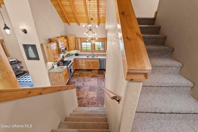 504 Hornby Pl, Dover, ID 83825 - staircase featuring wood ceiling, a chandelier, beamed ceiling, stone finish floors, and a high ceiling