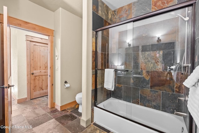 504 Hornby Pl, Dover, ID 83825 - bathroom with baseboards, combined bath / shower with glass door, toilet, and stone finish floors