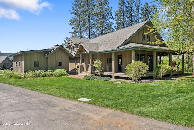 504 Hornby Pl, Dover, ID 83825 - view of front facade featuring board and batten siding, a porch, roof with shingles, and a front yard