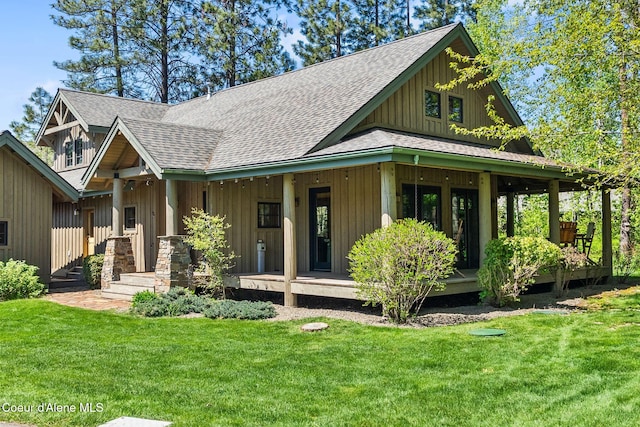 504 Hornby Pl, Dover, ID 83825 - view of front of home with a shingled roof, covered porch, a front lawn, and board and batten siding