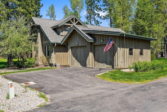 504 Hornby Pl, Dover, ID 83825 - chalet / cabin featuring roof with shingles, driveway, board and batten siding, and an attached garage