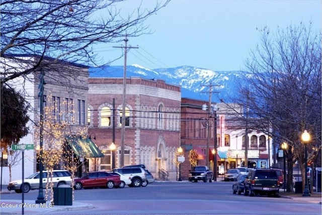 504 Hornby Pl, Dover, ID 83825 - view of asphalt street featuring a mountain view, street lights, sidewalks, and curbs